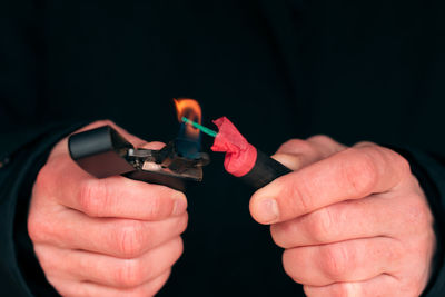 Close-up of hands holding candles
