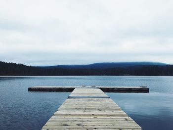 Pier over lake against sky