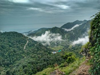 Scenic view of mountains against cloudy sky