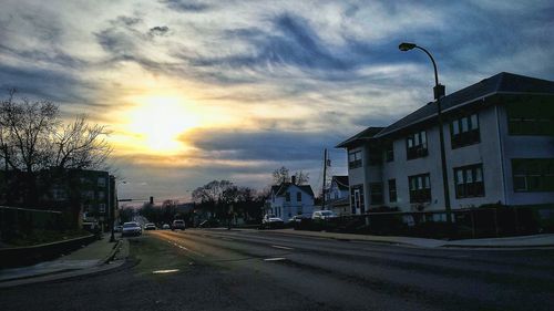 Road against cloudy sky at sunset