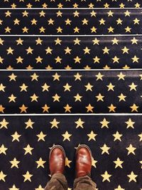 Low section of person standing on wooden floor