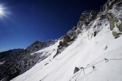 Scenic view of snowcapped mountains against clear blue sky