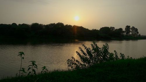 Scenic view of lake against sky during sunset