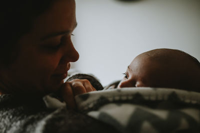 Close-up of woman with baby boy at home