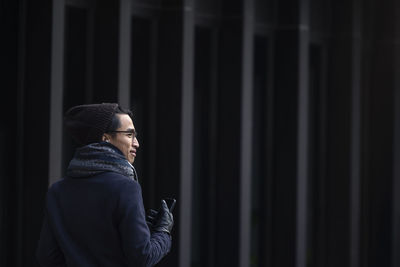 Handsome man with smartphone on street