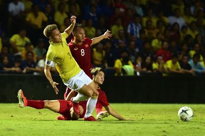 Full length of man playing soccer ball on field