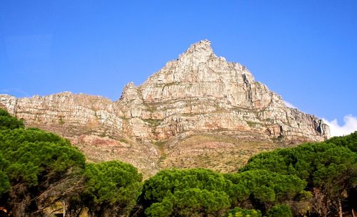 Low angle view of mountain against blue sky