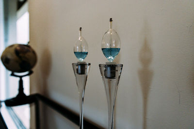 Close-up of kerosene lamps against wall