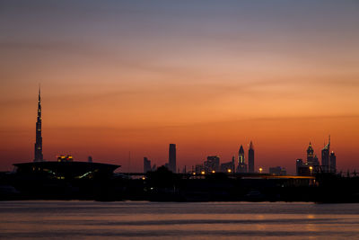 Silhouette ship by sea against sky during sunset