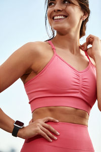 Midsection of woman standing against clear sky