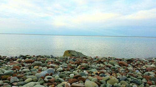 Scenic view of sea against cloudy sky