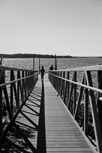 Pier over sea against clear sky