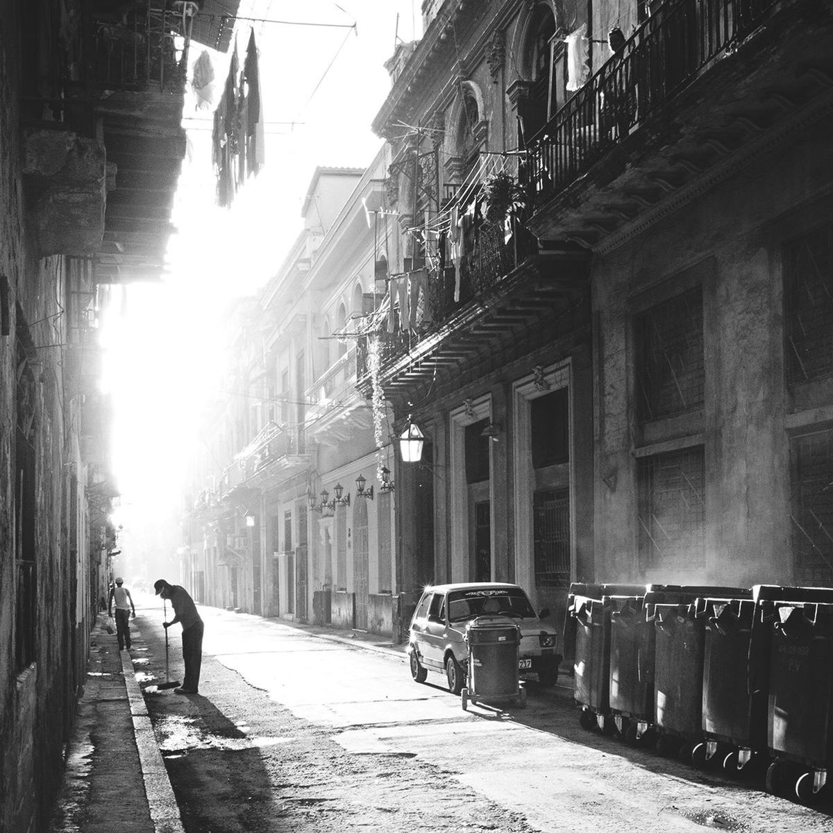 building exterior, architecture, built structure, walking, street, men, lifestyles, city, person, full length, rear view, city life, the way forward, sunlight, leisure activity, residential structure, cobblestone, residential building