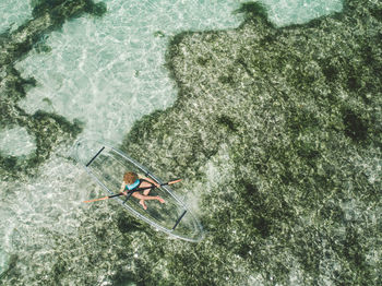 Aerial view of woman over inflatable boat in sea