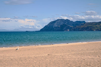 Scenic view of sea and mountains against sky