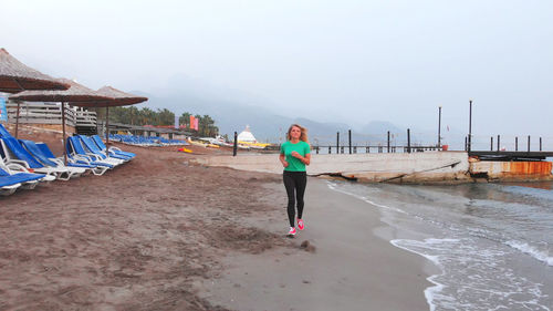 Rear view of people walking on beach