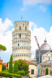 Tower of building against cloudy sky