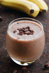 Close-up of drink and bananas on table