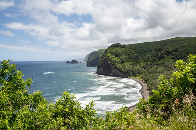 Scenic view of sea and mountains against sky