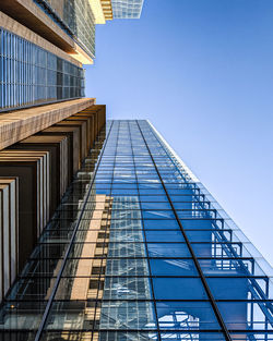 Low angle view of modern building against clear blue sky