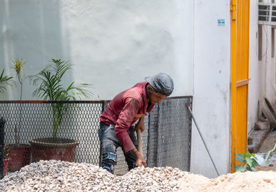 Man working by built structure