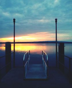 Pier on sea at sunset