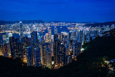 High angle view of illuminated buildings in city at night