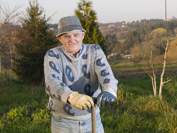 Portrait of smiling man standing on field