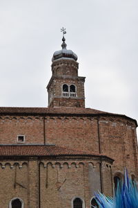 Low angle view of bell tower against sky