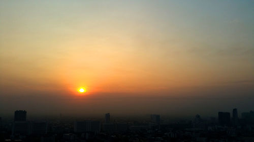 Silhouette buildings against sky during sunset