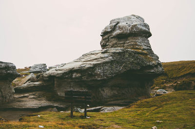 Rock formation on landscape against clear sky