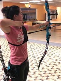 Young woman practicing archery