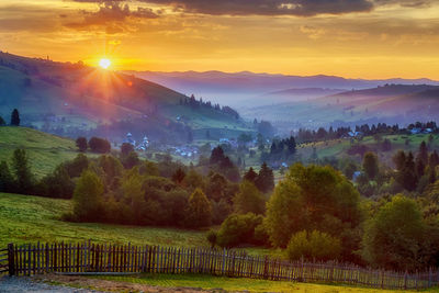 Scenic view of field against sky during sunset