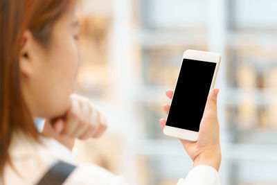 Midsection of man using mobile phone