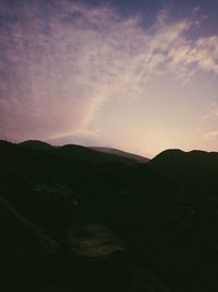 Scenic view of silhouette mountains against sky at sunset