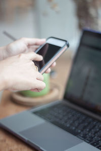 Midsection of man using mobile phone