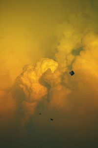 Low angle view of hot air balloons against sky during sunset