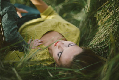 Midsection of woman resting on field