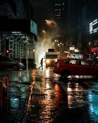 Cars on city street during rainy season at night