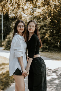 Portrait of two beautiful caucasian girls in a park.