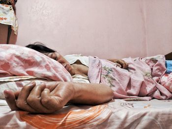 Woman sleeping on bed at home
