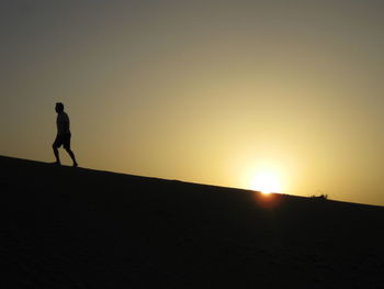 Silhouette of woman at sunset