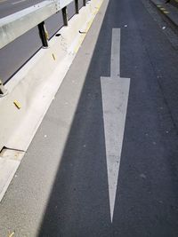 High angle view of arrow symbol on road