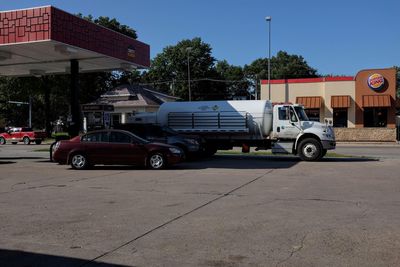 Vehicles on road against buildings in city