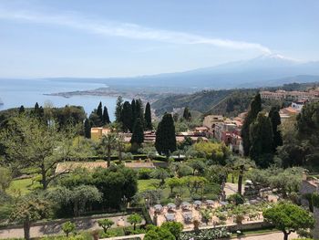 Panoramic view of trees and buildings against sky