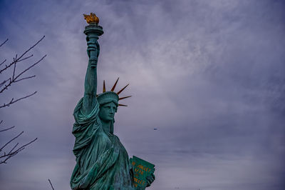 Low angle view of statue against cloudy sky