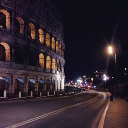 Illuminated city street at night