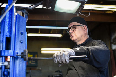 Side view of man working in factory