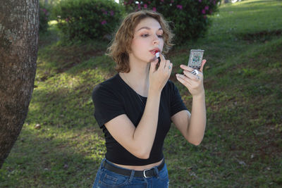 Portrait of a beautiful young woman holding plants