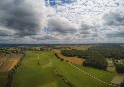 Scenic view of agricultural field against sky